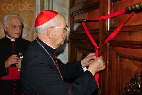 Vatican Camerlengo Cardinal Eduardo Martinez Somalo of Spain (R), seals the door to late Pope John Paul II's apartments in Vatican City April 12, 2005. 