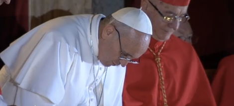 In a bold departure from tradition, Pope Francis bows before the crowd to receive their blessing before imparting his.